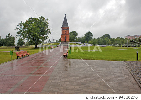 An alley with a central composition - a 27-meter red-brick chapel. Memorial complex "Buinichskoe Pole". Buynichi. Mogilev region. Belarus 94510270