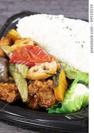 Delicious fried chicken bento box with black vinegar sauce Delicious fried chicken bento box with black vinegar sauce 94510554