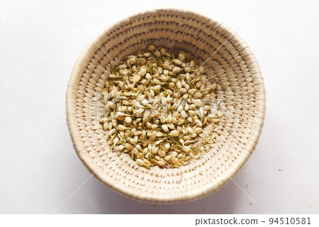 close up of jasmine dry flower in a container on table  94510581