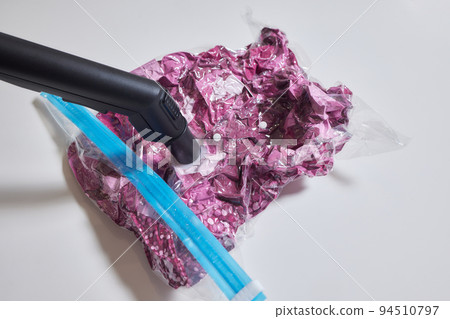 Space saver saving seal bag sucking air vacuum clothing storage compressed package. 94510797