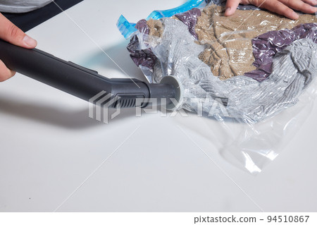 Space saver saving seal bag sucking air vacuum clothing storage compressed package. 94510867