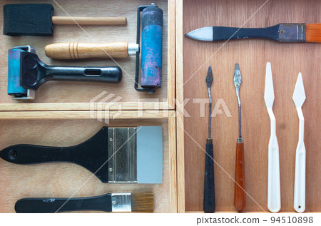 Art and craft DIY tools box. Rubber roller, foam brush, knife palette and paint brush on wooden tray. Art and craft DIY tools box. Rubber roller, foam brush, knife palette and paint brush on wooden tray. 94510898