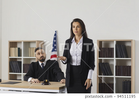Female lawyer speak to public in courthouse 94511195