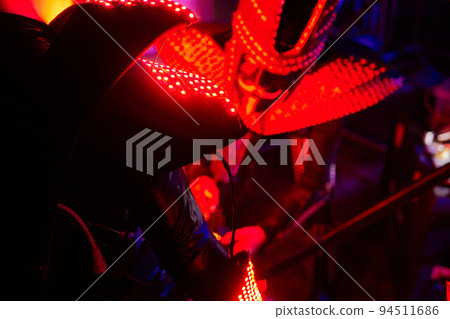 dancers in led suits on dark background, colored show. dancers in led suits on dark background, colored show. 94511686