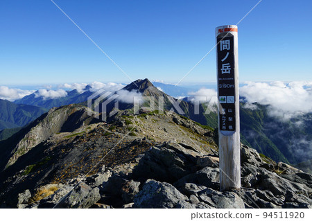 Southern Alps Ainodake summit sign and Kitadake in the back Southern Alps Ainodake summit sign and Kitadake in the back 94511920