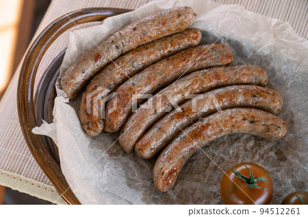 Grilled sausages with sauce and vegetable 94512261