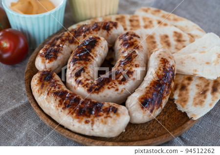 Grilled sausages with sauce and vegetable Grilled sausages with sauce and vegetable 94512262