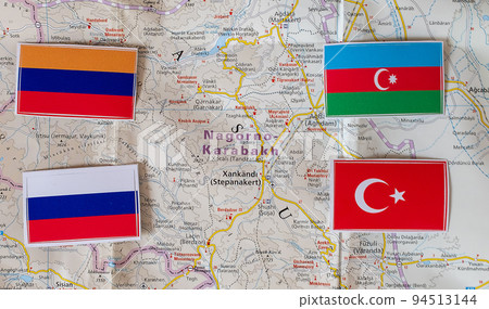 Flags of Armenia, Russia, Azerbaijan and Turkey on the background of the map of Nagorno-Karabakh 94513144