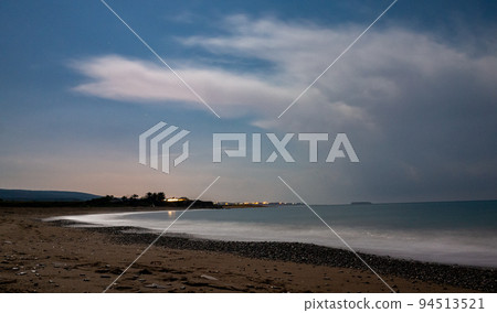 Sandy and pebble beach of the Mediterranean Sea, shot in calm weather at night with a long exposure. Sandy and pebble beach of the Mediterranean Sea, shot in calm weather at night with a long exposure. 94513521