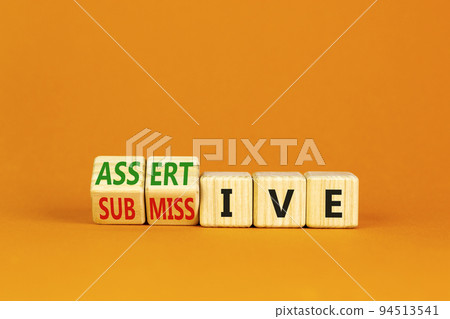 Submissive or assertive symbol. Concept words Submissive and assertive on wooden cubes. Beautiful orange background. Business, psychological submissive assertive concept. Copy space. Submissive or assertive symbol. Concept words Submissive and assertive on wooden cubes. Beautiful orange background. Business, psychological submissive assertive concept. Copy space. 94513541