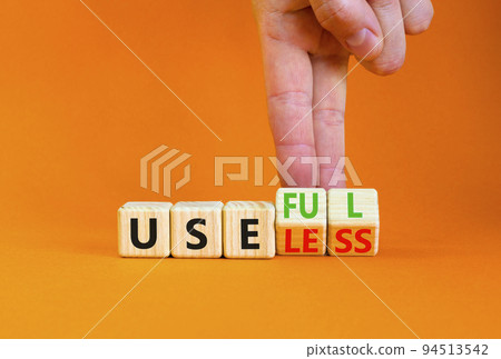 Useful or useless symbol. Concept words Useful or Useless on wooden cubes. Businessman hand. Beautiful orange table orange background. Business useful or useless concept. Copy space. Useful or useless symbol. Concept words Useful or Useless on wooden cubes. Businessman hand. Beautiful orange table orange background. Business useful or useless concept. Copy space. 94513542