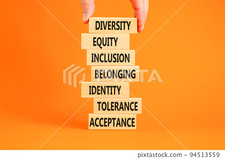 Diversity, inclusion symbol. Diversity belonging inclusion equity identity tolerance acceptance words on blocks. Businessman hand. Beautiful orange background. Diversity inclusion belonging concept. Diversity, inclusion symbol. Diversity belonging inclusion equity identity tolerance acceptance words on blocks. Businessman hand. Beautiful orange background. Diversity inclusion belonging concept. 94513559