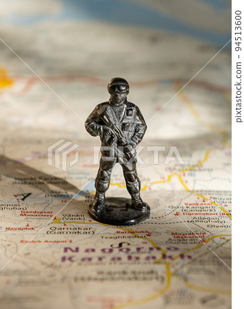 A figurine of an armed soldier on the map of Nagorno-Karabakh. 94513600