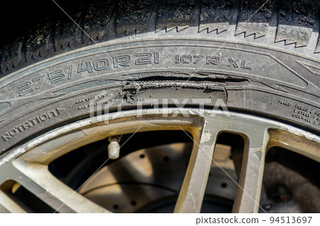 Large long mechanical cut damage on tire sidewall Large long mechanical cut damage on tire sidewall 94513697