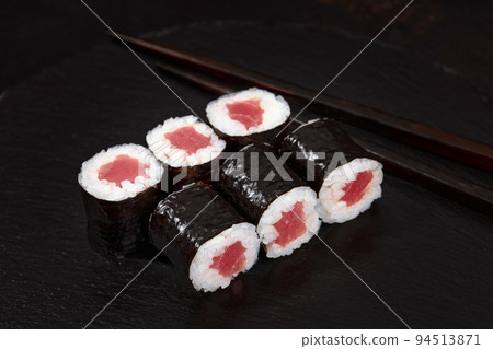 Set of tuna sushi rolls on black desk background Set of tuna sushi rolls on black desk background 94513871