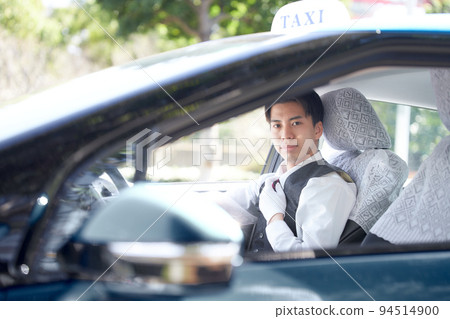 Young taxi driver looking at you with a smile 94514900