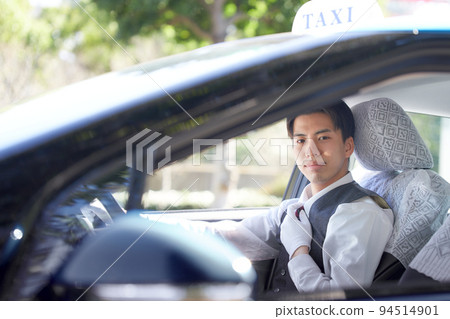 Young taxi driver looking at you with a smile 94514901