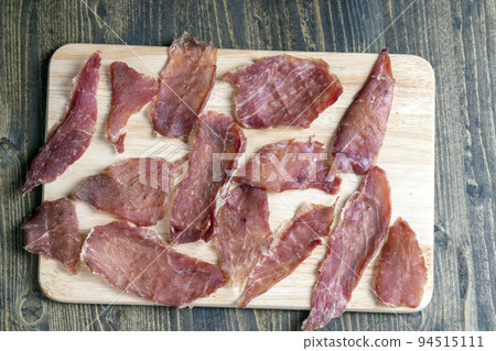 thin pieces of dried meat with spices thin pieces of dried meat with spices 94515111