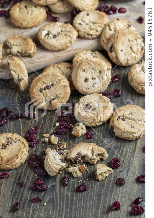 delicious dried cookies made of high-quality flour with dried red cranberries on the table 94515761