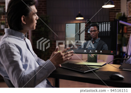 Male freelancer attending videocall conference on computer, talking to colleagues on online videoconference call with webcam. Using remote teleconference meeting on internet telework chat. 94516151