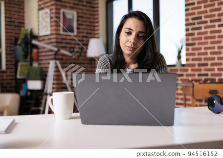 Business woman doing remote online job at home, using laptop to send email and analyze research information. Working on internet report with startup network or attending school class lesson. Business woman doing remote online job at home, using laptop to send email and analyze research information. Working on internet report with startup network or attending school class lesson. 94516152
