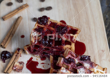 soft waffles with red cherry jam on a serving board soft waffles with red cherry jam on a serving board 94516484