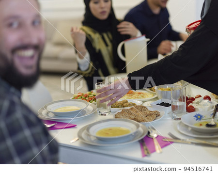 Muslim family making iftar dua to break fasting during Ramadan. Muslim family making iftar dua to break fasting during Ramadan. 94516741