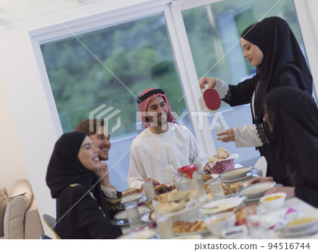Eid Mubarak Muslim family having Iftar dinner drinking water to break feast. Eating traditional food during Ramadan feasting month at home. The Islamic Halal Eating and Drinking at modern western Isla Eid Mubarak Muslim family having Iftar dinner drinking water to break feast. Eating traditional food during Ramadan feasting month at home. The Islamic Halal Eating and Drinking at modern western Isla 94516744