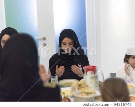 Muslim family making iftar dua to break fasting during Ramadan. Muslim family making iftar dua to break fasting during Ramadan. 94516745
