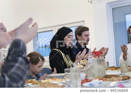 Muslim family making iftar dua to break fasting during Ramadan. Muslim family making iftar dua to break fasting during Ramadan. 94516809