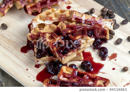soft waffles with red cherry jam on a serving board soft waffles with red cherry jam on a serving board 94516863