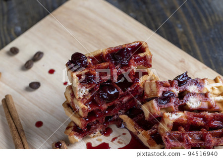 soft waffles with red cherry jam on a serving board soft waffles with red cherry jam on a serving board 94516940