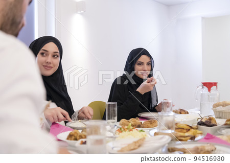 Muslim family making iftar dua to break fasting during Ramadan. 94516980