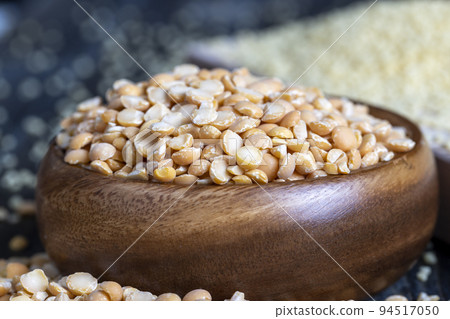 Raw, dry and not cooked porridge of peas on the table Raw, dry and not cooked porridge of peas on the table 94517050