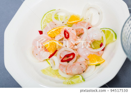 Ceviche with shrimps, lime, tangerine and hot pepper Ceviche with shrimps, lime, tangerine and hot pepper 94517530