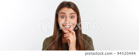 Close-up portrait of surprised beautiful girl holding her head in amazement and open-mouthed. Over white background 94520494