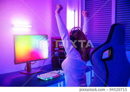 Asian gamer playing online video game excited on desktop computer 94520713