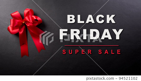 Top view of red ribbon decoration on blackboard background. Shop Top view of red ribbon decoration on blackboard background. Shop 94521102