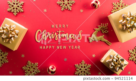 Christmas and new year background concept. Top view of Christmas gift box, reindeer, christmas ball and snowflake on red background. 94521114