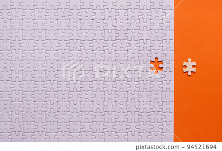 Jigsaw puzzle white color,Puzzle pieces grid,Success mosaic solution template,Horizontal on orange background copy space for text,Top view Jigsaw puzzle white color,Puzzle pieces grid,Success mosaic solution template,Horizontal on orange background copy space for text,Top view 94521694