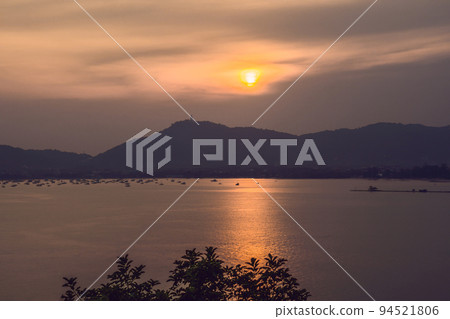 Sunset over the sea and the island of Phuket, Thailand 94521806
