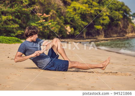young male working out on beach, sporty man doing exercises young male working out on beach, sporty man doing exercises 94521866