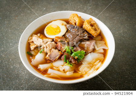 paste of rice flour or boiled Chinese pasta square in clear soup 94521904