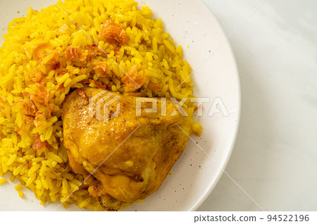 Chicken Biryani or Curried rice and chicken - Thai-Muslim version of Indian biryani, with fragrant yellow rice and chicken Chicken Biryani or Curried rice and chicken - Thai-Muslim version of Indian biryani, with fragrant yellow rice and chicken 94522196