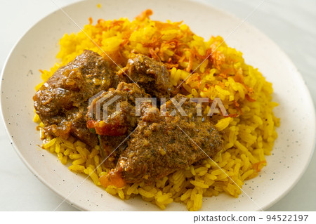 Beef Biryani or Curried rice and beef - Thai-Muslim version of Indian biryani, with fragrant yellow rice and beef Beef Biryani or Curried rice and beef - Thai-Muslim version of Indian biryani, with fragrant yellow rice and beef 94522197