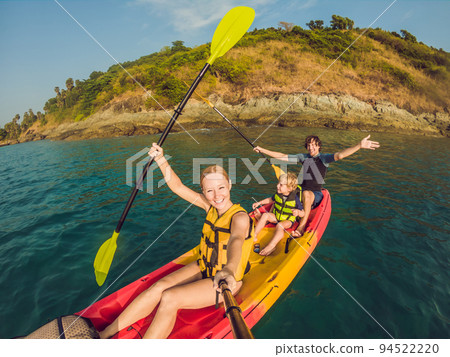 happy family with kid kayaking at tropical ocean happy family with kid kayaking at tropical ocean 94522220