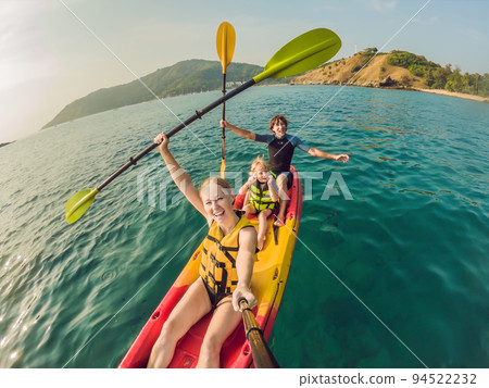 happy family with kid kayaking at tropical ocean 94522232