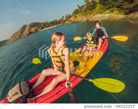 happy family with kid kayaking at tropical ocean 94522257