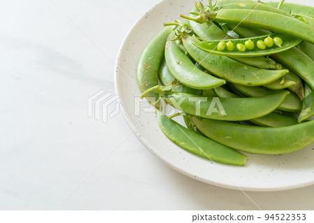 fresh sweet green peas on plate fresh sweet green peas on plate 94522353