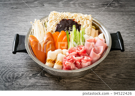 Budae Jjigae or Budaejjigae (Army stew or Army base stew). It is loaded with Kimchi, spam, sausages, ramen noodles and much more 94522426